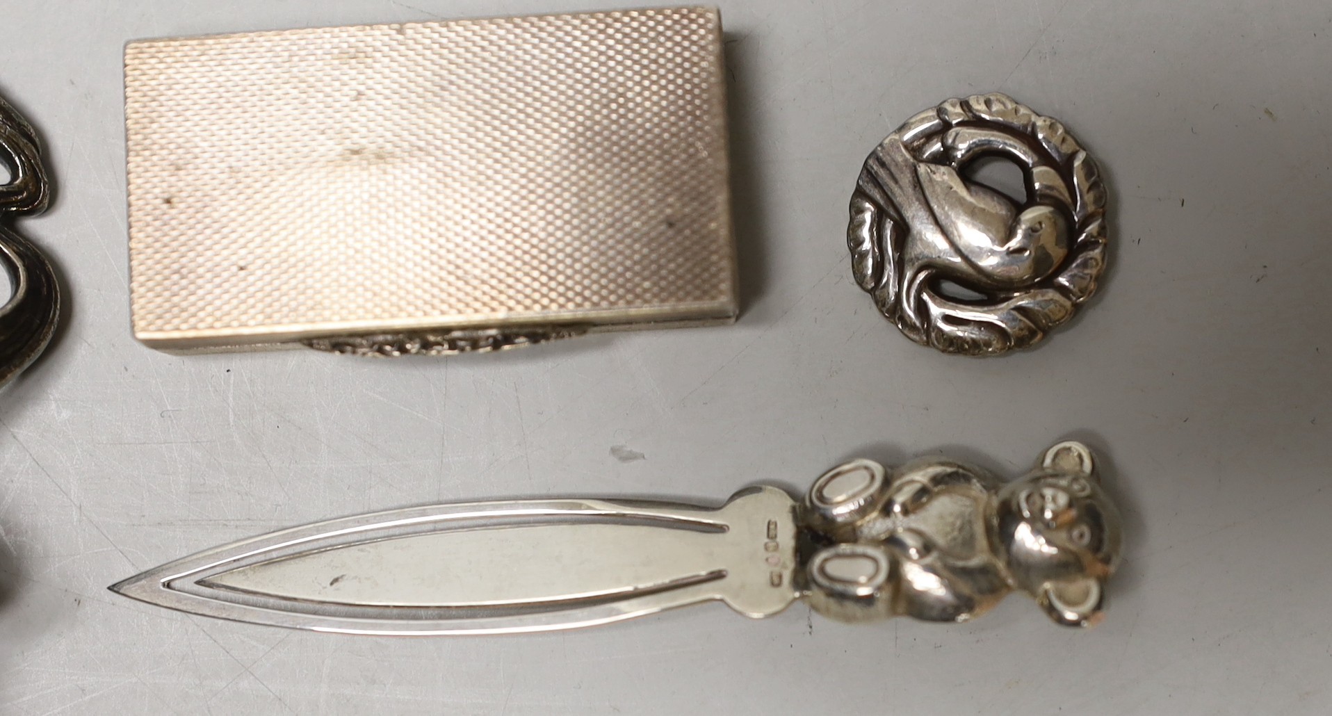 An Art Nouveau metal mounted cork stopper, a Georg Jensen sterling brooch, no. 191, an engine turned silver box and novelty bookmark.